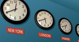 Wall clocks showing different time zones